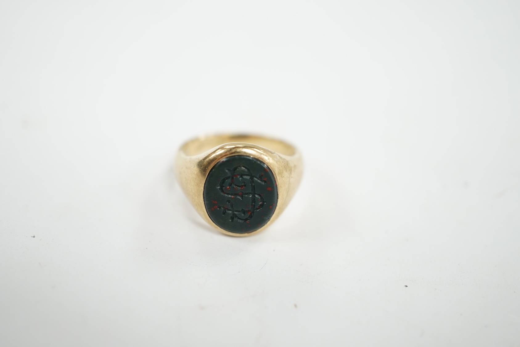 A 9ct gold and bloodstone set signet ring, with carved initial and interior inscription, size J/K, gross weight 5.9 grams. Condition - poor